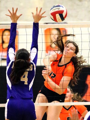 El Paso High’s Spencer Spier, 12, fires a shot past Melinda Vargas of Burges during their volleyball matchup Tuesday night at C.D. Jarvis Gymnasium.