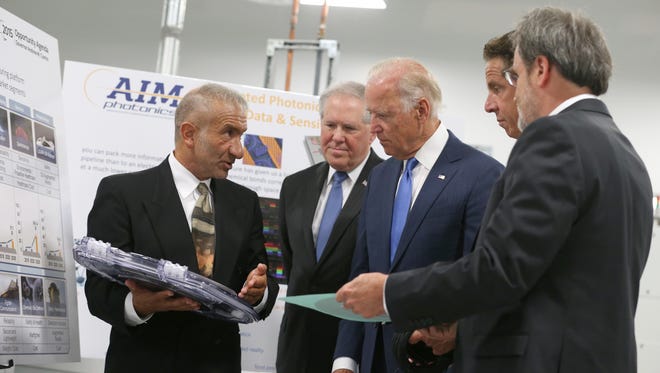 Dr. Alain Kaloyeros, founding President and CEO of SUNY Polytechnic Institute, left, and Michael Liehr, Executive Vice President of Innovation and Technology, Colleges of Nanoscale Science and Engineering, SUNY Polytechnic Institute, right, brief Vice President Joe Biden, center, New York Gov. Andrew Cuomo, second from right, and Defense Department Undersecretary Frank Kendall, as they visit SUNY Poly Canal Ponds in this 2015 file photo.