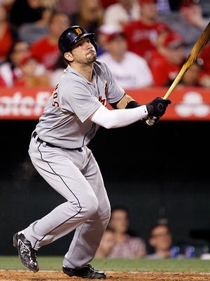 Nick Castellanos hits a sacrifice fly during Saturday night's loss to the Angels.