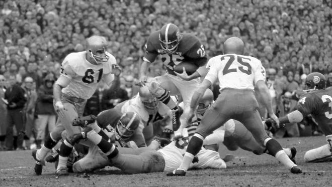 Regis “Reggie” Cavender (25) leaps through the Irish line; he scored MSU’s lone touchdown that day. The nation’s two top-ranked teams, undefeated Michigan State and Notre Dame, battled to a 10-10 tie on Nov. 19, 1966.