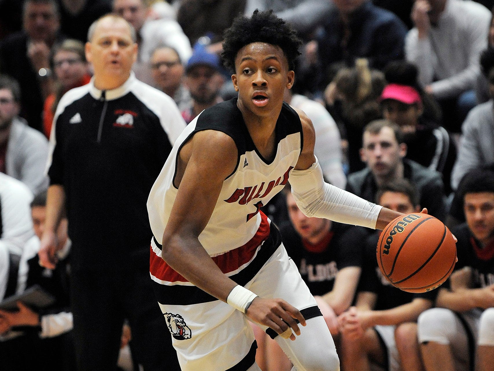 New Albany head coach Jim Shannon (in back) watches as Romeo Langford (1) drives against Providence on Friday at New Albany High School. New Albany won 55-40.