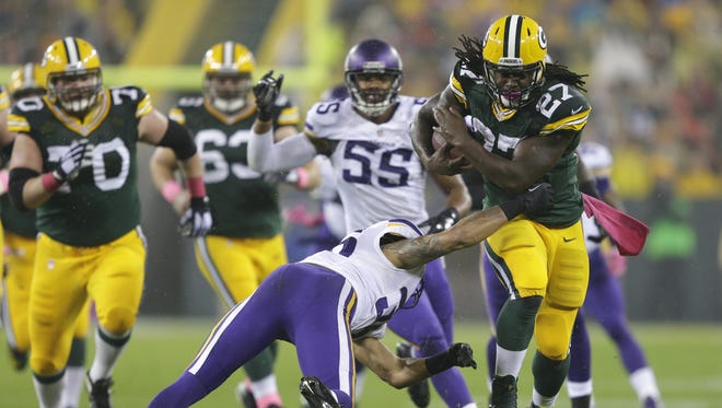 Green Bay Packers running back Eddie Lacy runs for a first down against Minnesota Vikings strong safety Robert Blanton in the first quarter.
