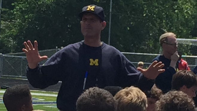 Michigan football coach Jim Harbaugh addresses satellite campers.