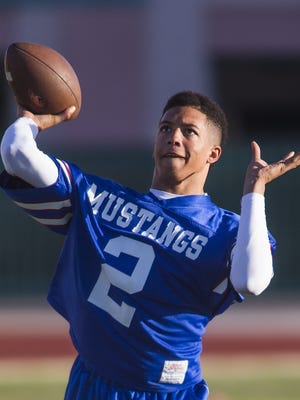 North High School quarterback Torey Blevins fires a pass during practice at North High School early Wednesday morning, May 6, 2015.