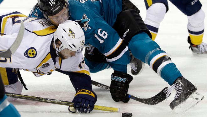 San Jose Sharks' Nick Spaling (16) is tangled with Nashville Predators' Craig Smith (15) during a face-off during the second period of Game 5 in the Western Conference semifinals on May 7, 2016.