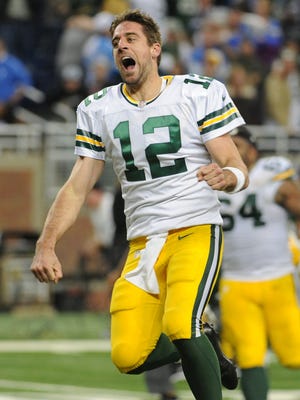 Aaron Rodgers celebrates his game-winning touchdown pass against the Lions Thursday.
