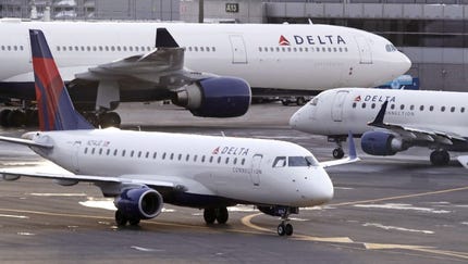 A Delta Connection Embraer 175 aircraft,...