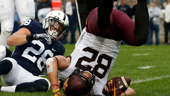 Minnesota's Drew Wolitarsky (82) lands in the end zone after a catch for a touchdown against Penn State during the first half of an NCAA college football game in State College, Pa., Saturday, Oct. 1, 2016.