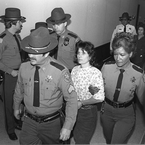 Kathy Boudin is escorted by police on Nov. 24, 198