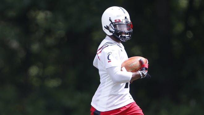 University of Cincinnati wide receiver Ralph David Abernathy runs the ball during the year's first football practice held at Higher Ground in West Harrison, Indiana Monday.
