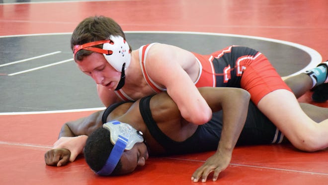 Riverheads' G.W. Shultz, top, won the 120-pound title at the combined VHSL Region 1A/1B wrestling tournament.