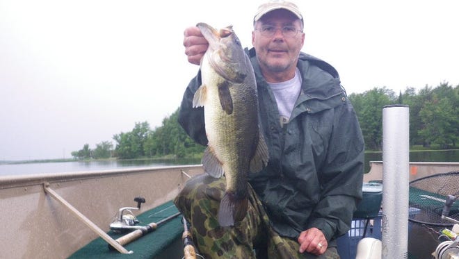 Skip Sommerfeldt with a bass caught in northern Wisconsin in July 2014.
