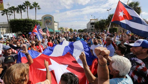 Cuban-Americans react to the death of Fidel Castro, Saturday, Nov. 26, 2016, in the Little Havana area in Miami. Castro, who led a rebel army to improbable victory in Cuba, embraced Soviet-style communism and defied the power of 10 U.S. presidents during his half century rule, died at age 90.
