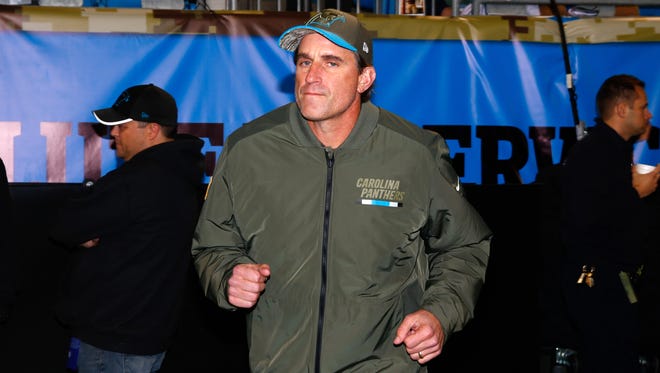Carolina Panthers offensive coordinator Mike Shula jogs onto the field prior to the game against the Miami Dolphins at Bank of America Stadium.