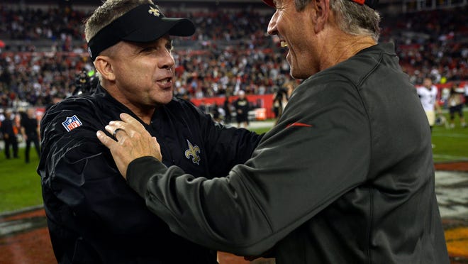 New Orleans Saints head coach Sean Payton, left, congratulates Tampa Bay Buccaneers head coach Dirk Koetter after the Buccaneers defeated the Saints 31-24 during an NFL football game Sunday, Dec. 31, 2017, in Tampa, Fla. (AP Photo/Jason Behnken)