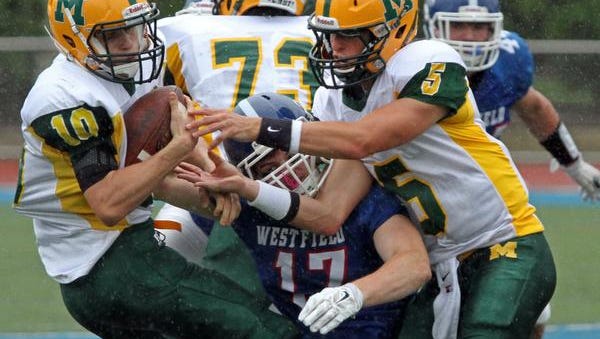 Montgomery's Wyatt Colangelo tries to break away from a tackle in action of Montgomery at Westfield in high school football, September 13 2014. Westfield NJ. Photo by Kathy Johnson BRI 0914 FB Montgomery