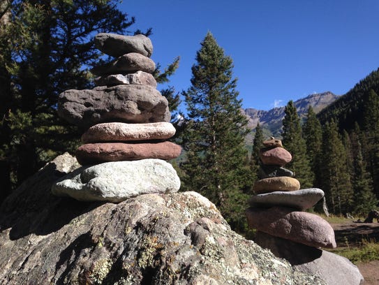 What is a pile of rocks that works as a trail marker called?