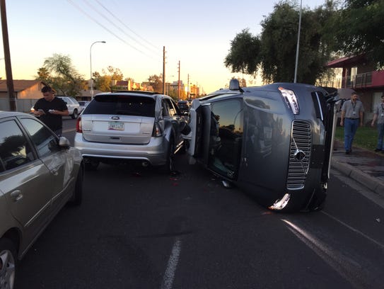 Scene from an accident in Tempe. The car on its side