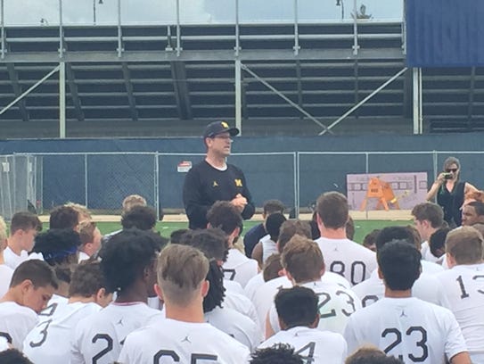 Michigan coach Jim Harbaugh speaks at the U-M elite