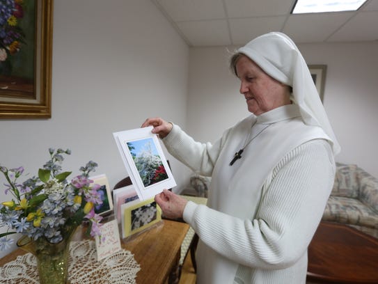 Sr. Mary Aimee with a photo she took, printed on a