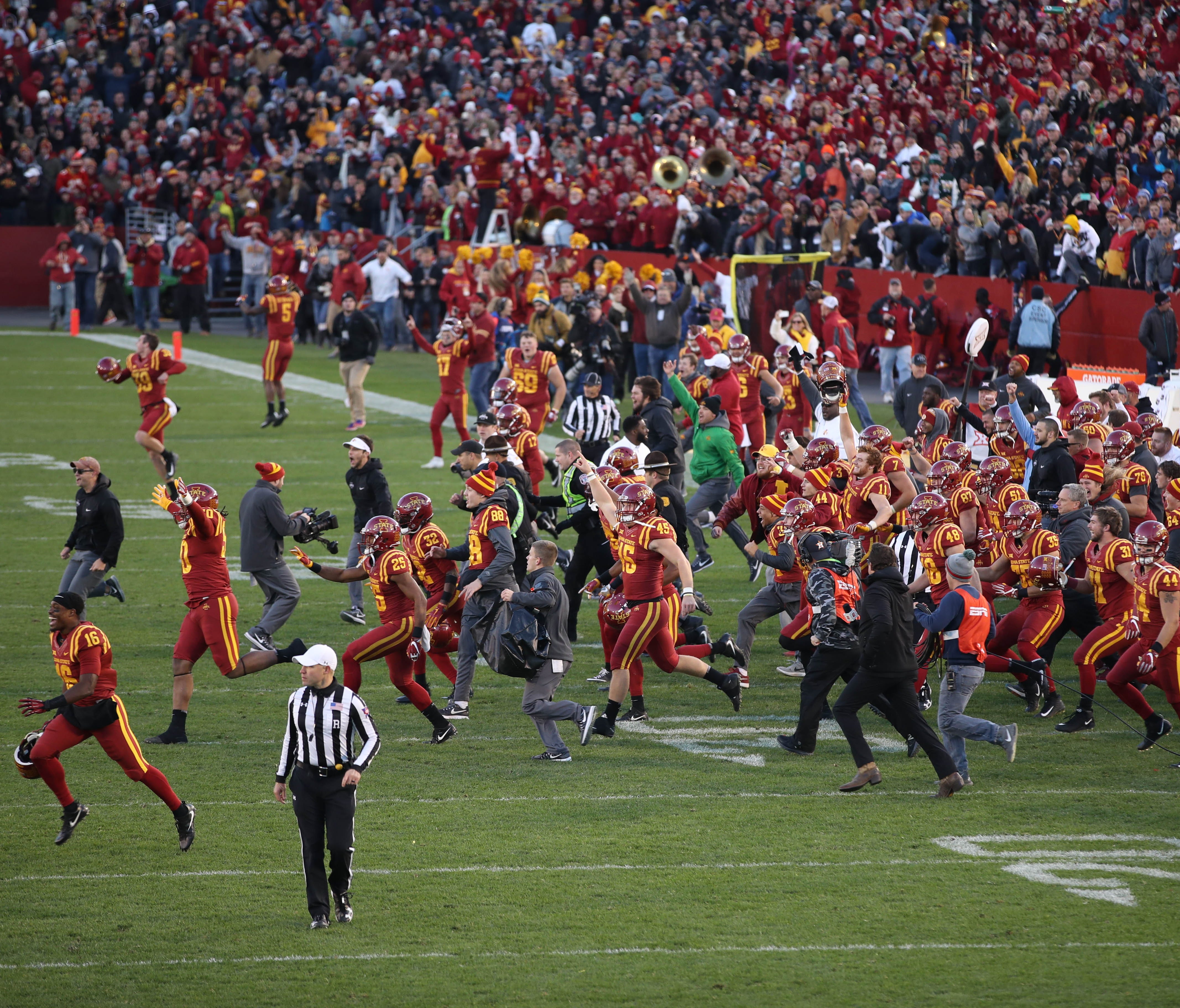 Iowa State Cyclones players rush the field after beating the TCU Horned Frogs at Jack Trice Stadium.