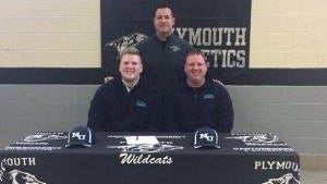 Plymouth senior lineman Austin Scheffer (seated, left) celebrates signing with Northwood University along with his dad, Lawrence Scheffer (seated, right) and Wildcats head football coach Mike Sawchuk (standing).