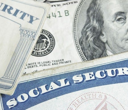 Social Security card with a hundred dollar bill