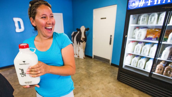 Patricia Tejeda, of Laveen, picks up bottled milk directly from the Danzeisen Dairy, Wednesday, April 15, 2015. The dairy is the only one in the state that puts milk in glass bottles.
