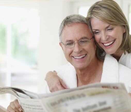 Older couple reading a newspaper