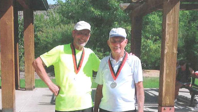 Fred Ehrlich, left, of York, and Art Barnes, right, of Littlestown, pose with their gold medals at the Huntsman Senior World Games in St. George, Utah. The pair won the men’s 75-79 doubles tennis division.