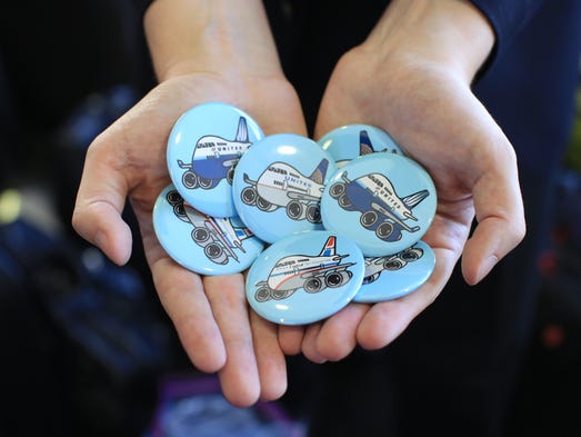 Kevin Weber hands out custom-made Boeing 747 pins,