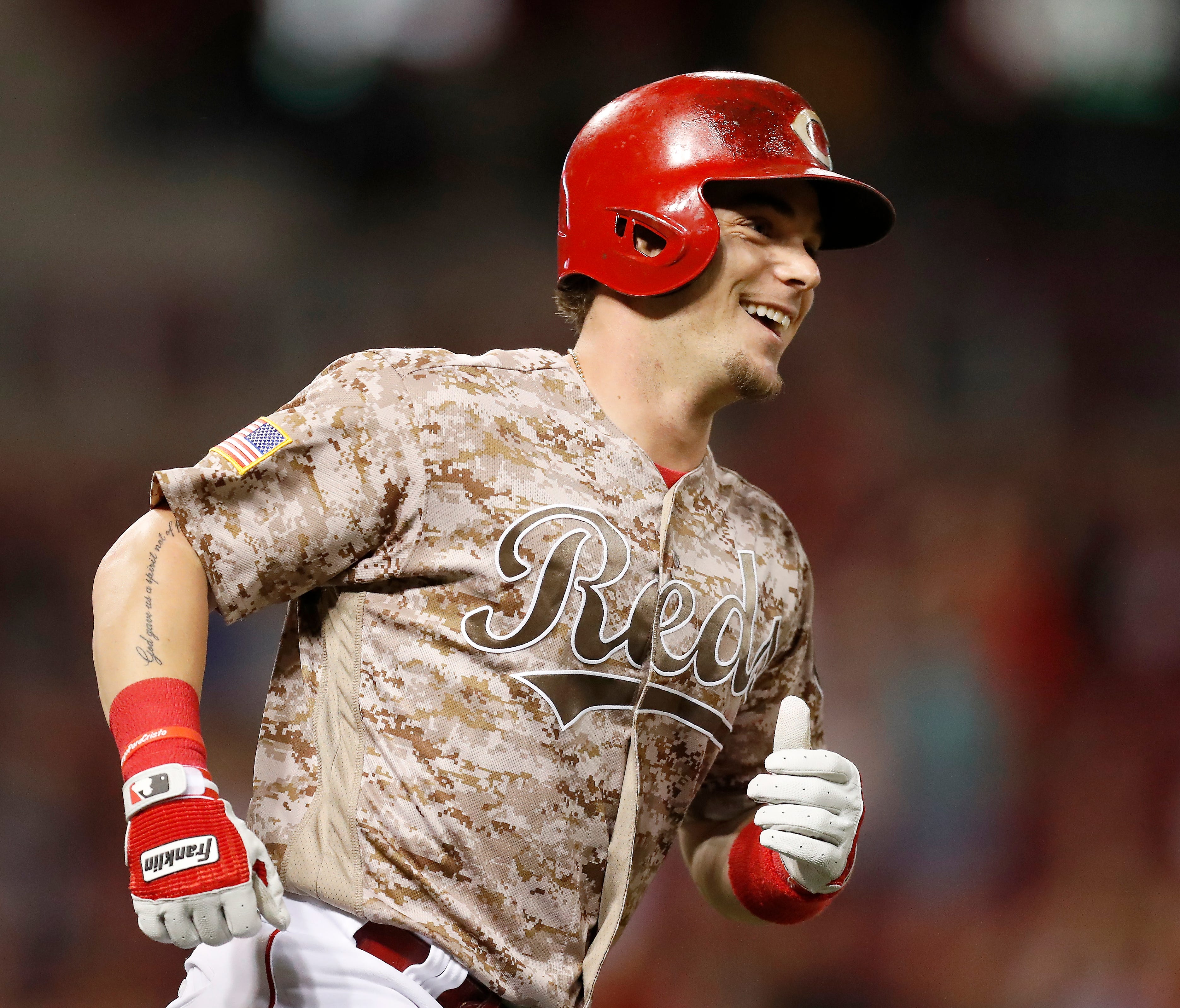The biggest smile in baseball Tuesday belonged to Cincinnati Reds second baseman Scooter Gennett , here rounding the bases after his record-tying fourth home run.
