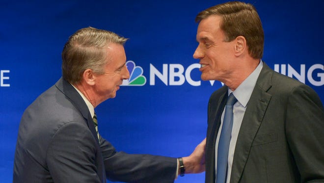 The candidates shake hands before the Fairfax County Chamber of Commerce hosts Virginia's U.S. Senate Debate between Democratic U.S. Sen. Mark Warner, right, and Republican challenger Ed Gillespie on Tuesday, Oct. 7, 2014 in McLean, Va. (AP Photo/The Washington Post, Bill O'Leary, Pool)