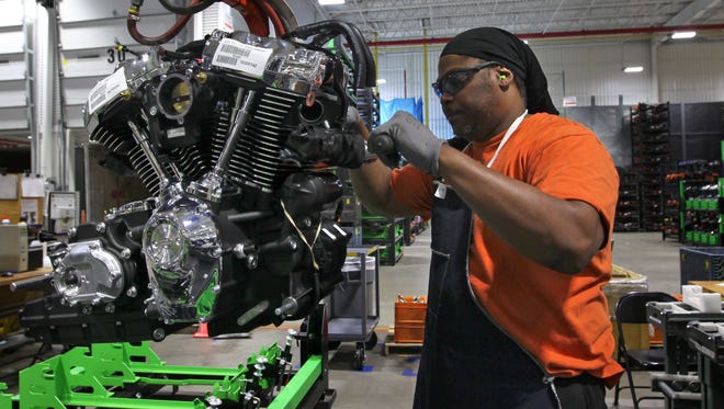 Michael Guster inspects and readies a new Harley-Davidson Milwaukee-Eight engine at the Pilgrim Road engine plant.