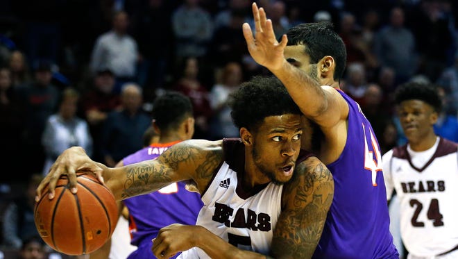 Missouri State Bears forward Obediah Church tries to drive past Evansville senior David Howard on Wednesday at JQH Arena in Springfield, Missouri.