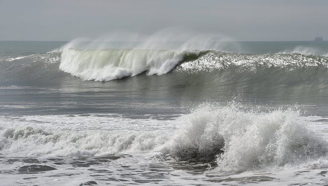 Waves crash along Ventura's South Beach near the mouth of Ventura Harbor.