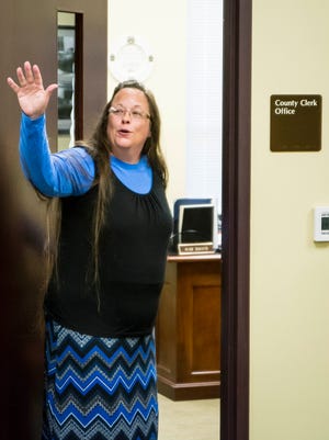 Rowan County Clerk Kim Davis, right, returns to her office Sept. 1, 2015, after arguing with David Moore and David Ermold, who were denied a marriage license at the Rowan County Clerk's Office in Morehead, Ky.