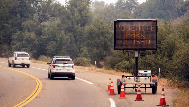 A sign on Highway 41 announces the closure of Yosemite National Park near Oakhurst. Closure of the Yosemite Valley has been extended.