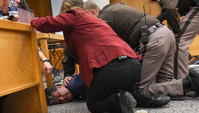 Randall Margraves, father of Lauren, Madison and Morgan Margraves is detained after trying to attack Larry Nassar on Friday, Feb. 2, 2018, in Eaton County Circuit Court during the second day of victim-impact statements in Charlotte, Mich.