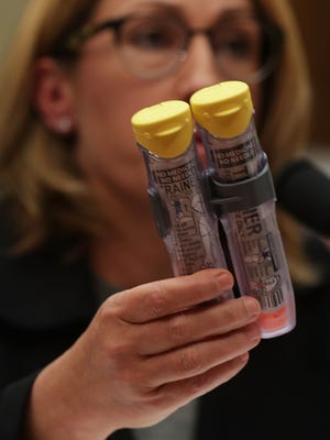Mylan CEO Heather Bresch holds up a twin-pack of EpiPens as she testifies during a hearing before the House Oversight and Government Reform Committee on Sept. 21 on Capitol Hill in Washington.