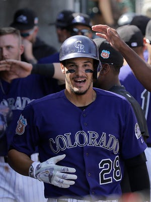 Colorado Rockies' third baseman Nolan Arenado is congratulated after hitting a 2-run home run against the Milwaukee Brewers during spring training last month. The Rockies are going to need to rely on Arenado to avoid their sixth consecutive losing season.