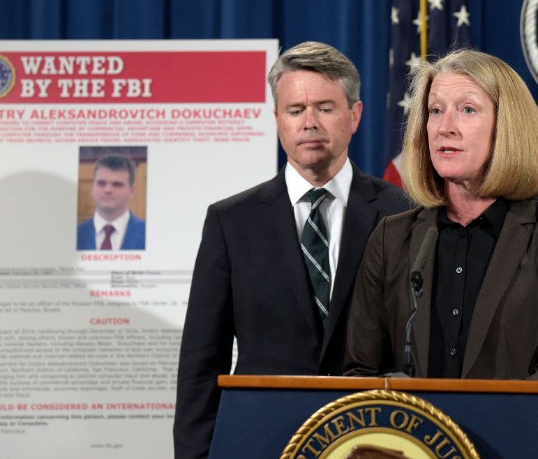 Acting Assistant Attorney General Mary McCord, right, accompanied by U.S. Attorney for the Northern District Brian Stretch, speak during a news conference at the Justice Department in Washington about the security breach at Yahoo.