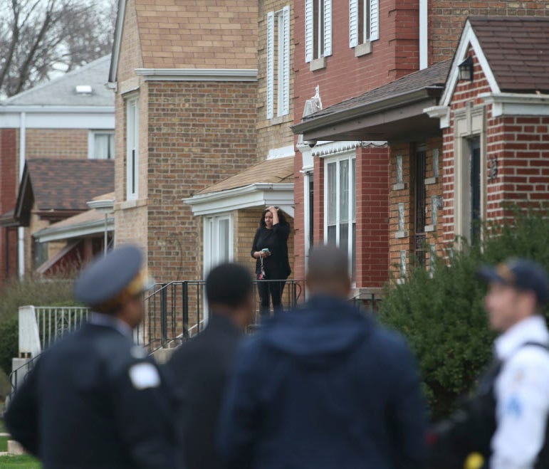 Authorities gather outside a home on the South Side of Chicago on April 10, 2017, after Cook County Circuit Court Judge Raymond Myles was shot to death. Myles was an associate judge in the court's criminal division.