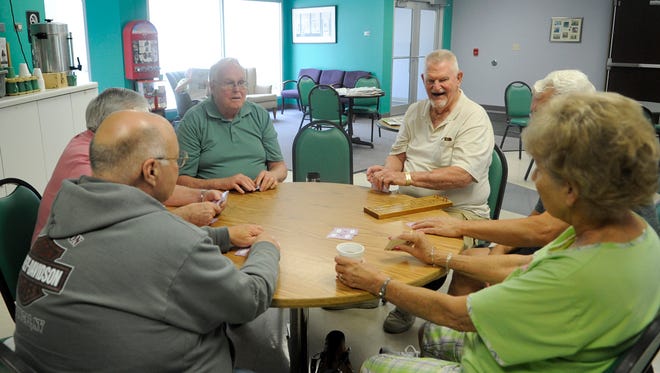 A group of people enjoy a card game among friends at the Whitney Senior Center in St. Cloud.