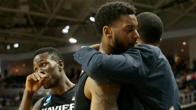 Xavier Musketeers guard Trevon Bluiett (5) hugs assistant coach Mike Pegues as he returns to the bench in the final minute of play.