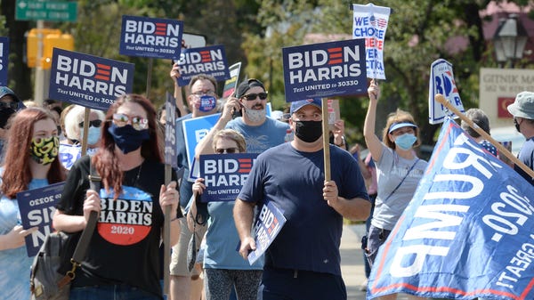People walking east on West Sixth Street, in suppo