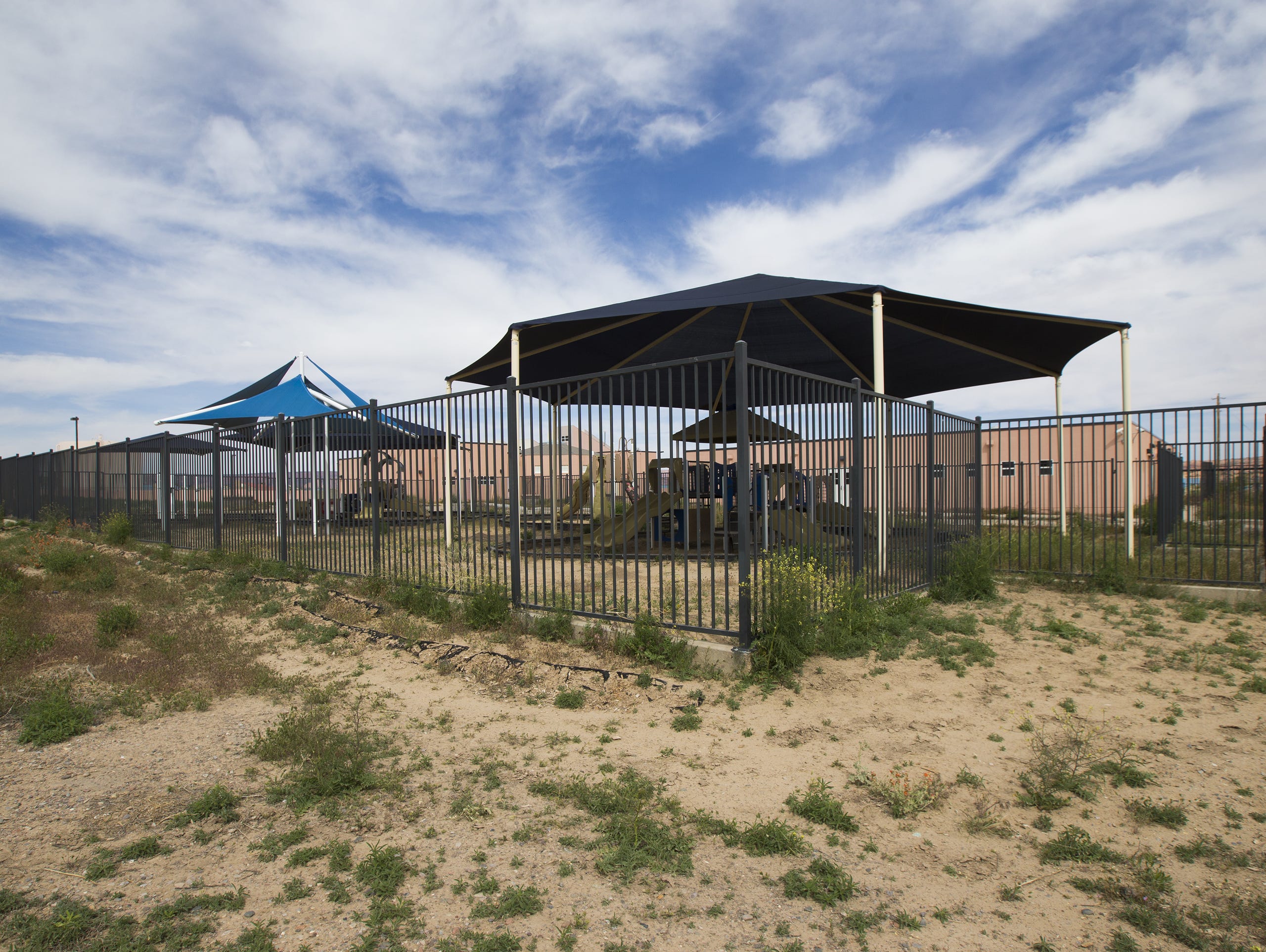 Weeds overrun a women's shelter built by the Navajo Housing Authority in Kayenta, AZ May 11, 2015. It was built but never occupied. Despite the NHA having over a quarter of a billion dollars of unspent grant money, many Navajos live in poor conditions.