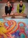 Reagan Mulvey and Rebecca Rieckmann sit by their Chalk Walk art last year.