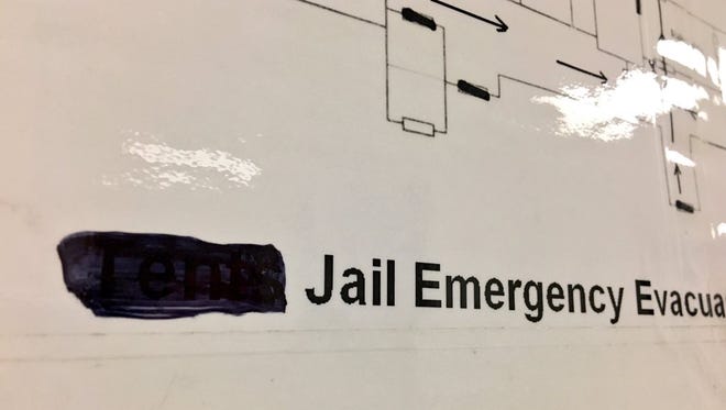 In an effort to transform the space formerly known as the Tent City jail, black marker was used to scribble out one word on the building's evacuation plan: "Tents."