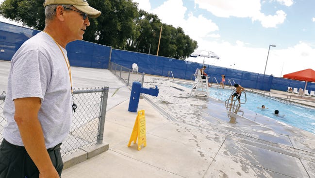 Steve Gromack, aquatic director for the city of Bloomfield, observes the Bloomfield Family Aquatic Center's outdoor pool area on July 7. The Bloomfield City Council on Tuesday will hear about plans to cut the budget for the upcoming fiscal year.  One possible cut would reduce hours at the aquatic center.